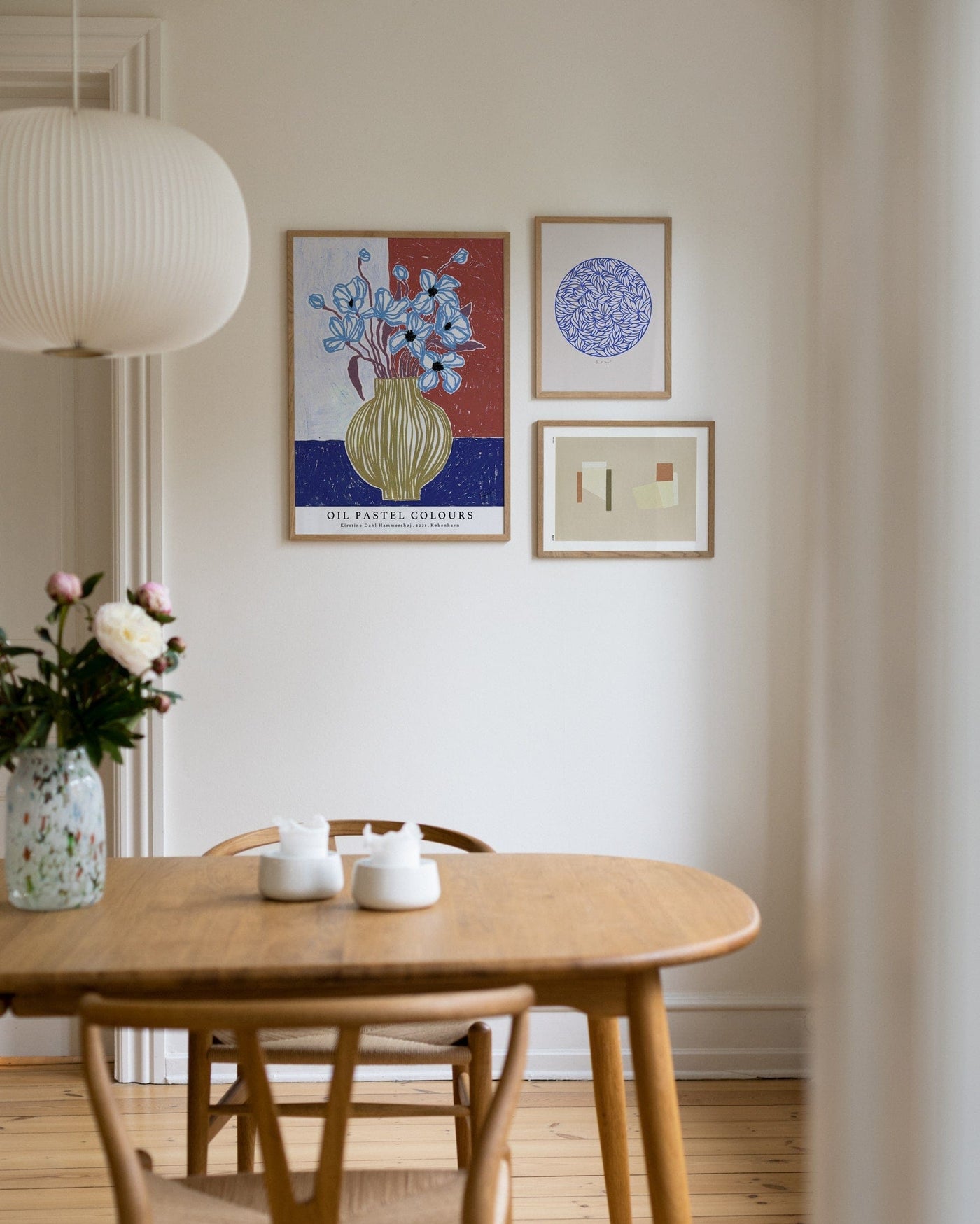 Colorful mix of art posters above the dining table